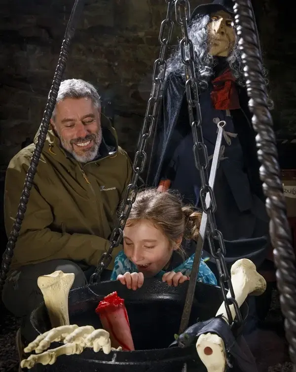 child-and-parent-looking-in-witches-cauldren
