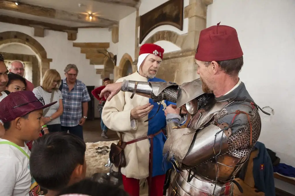 enactor-getting-dressed-into-armour