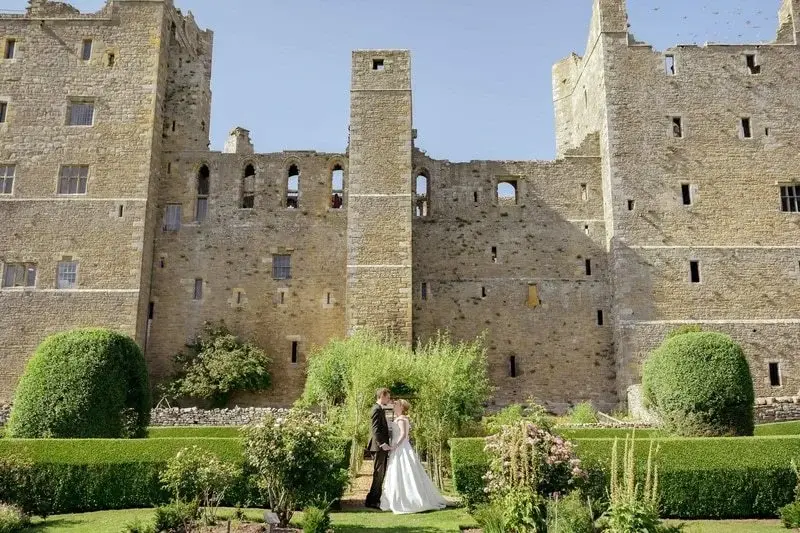 just-married-couple-in-front-of-bolton-castle