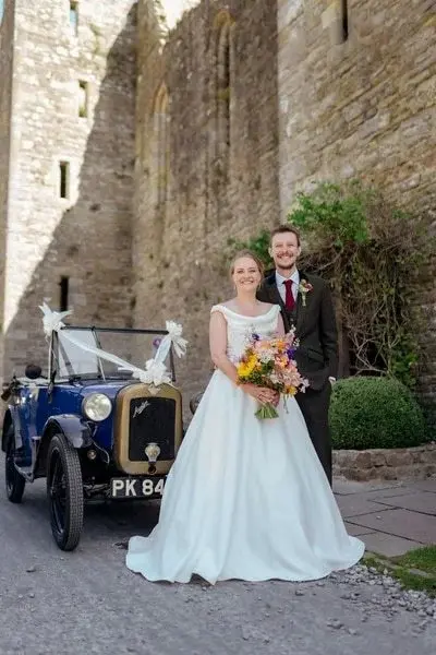 just-married-couple-with-vintage-car
